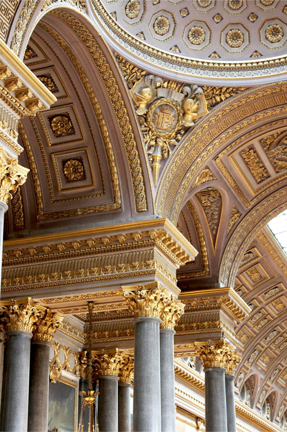 the ceiling of a building with many columns