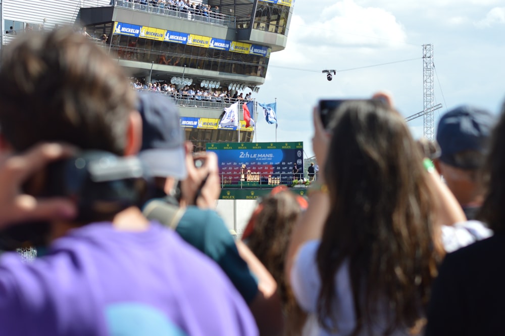 a crowd of people taking pictures of a baseball game