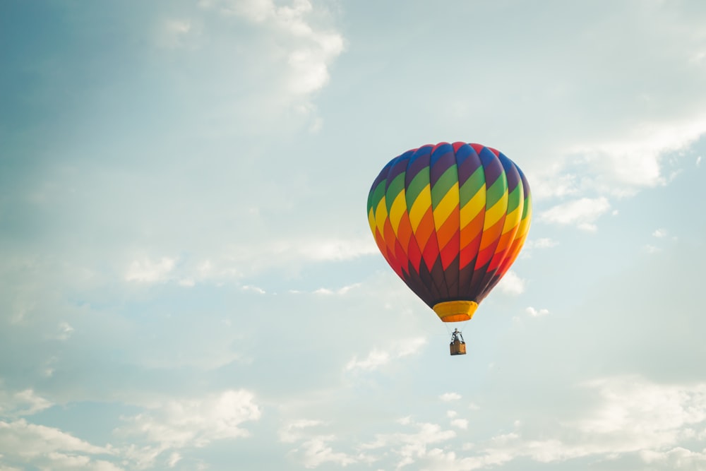 a colorful hot air balloon flying in the sky