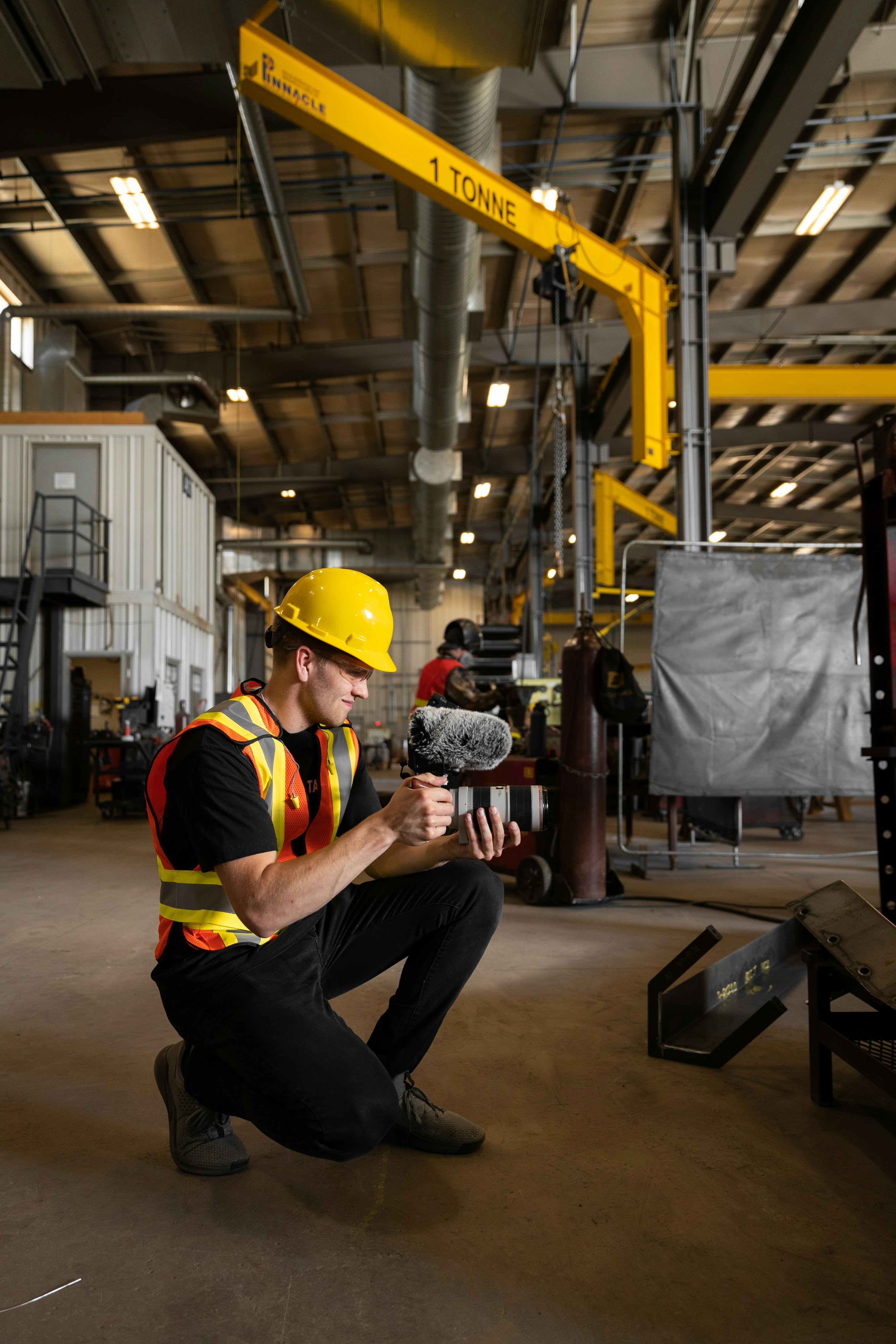 a man kneeling down while holding a birdby Tandem X Visuals