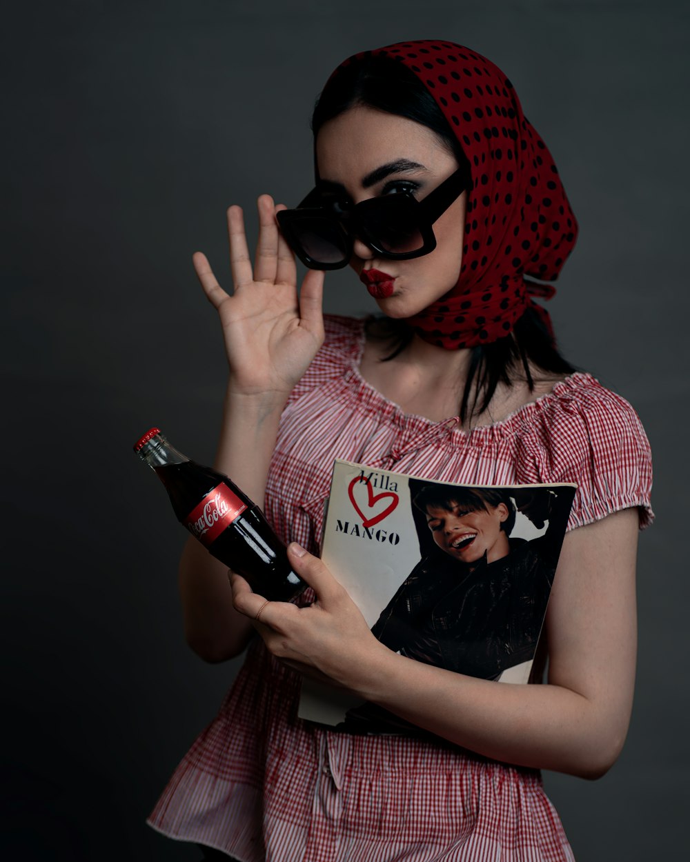 a woman in a red dress holding a bottle of wine