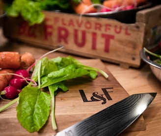 a cutting board with carrots and spinach on it