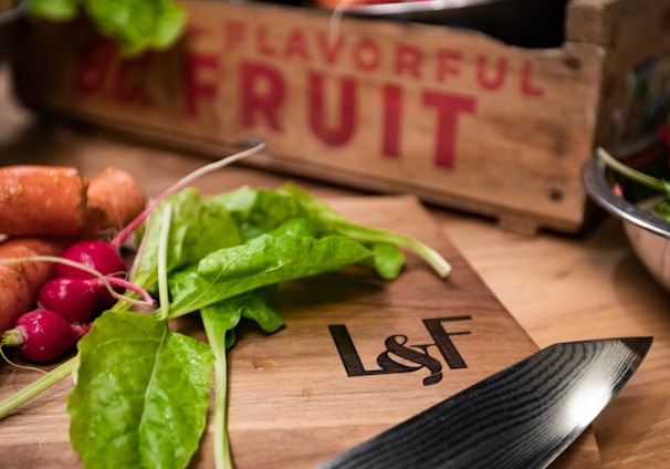 a cutting board with carrots and spinach on it