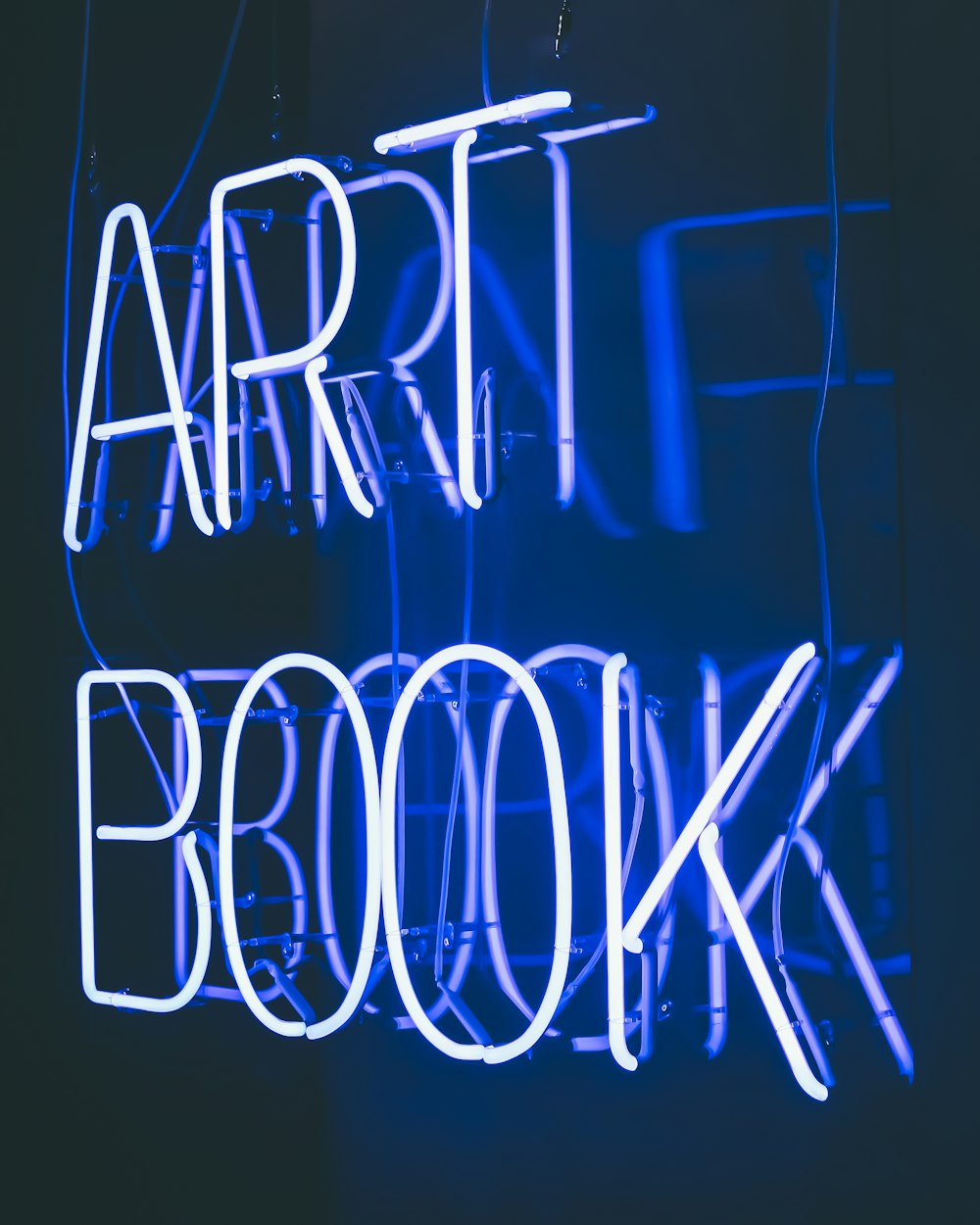a neon sign that reads art book