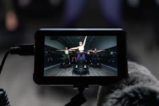 a person holding a camera with a video on it