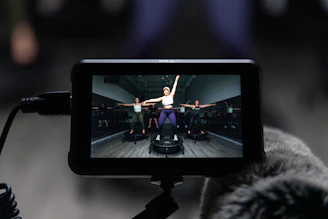 a person holding a camera with a video on it