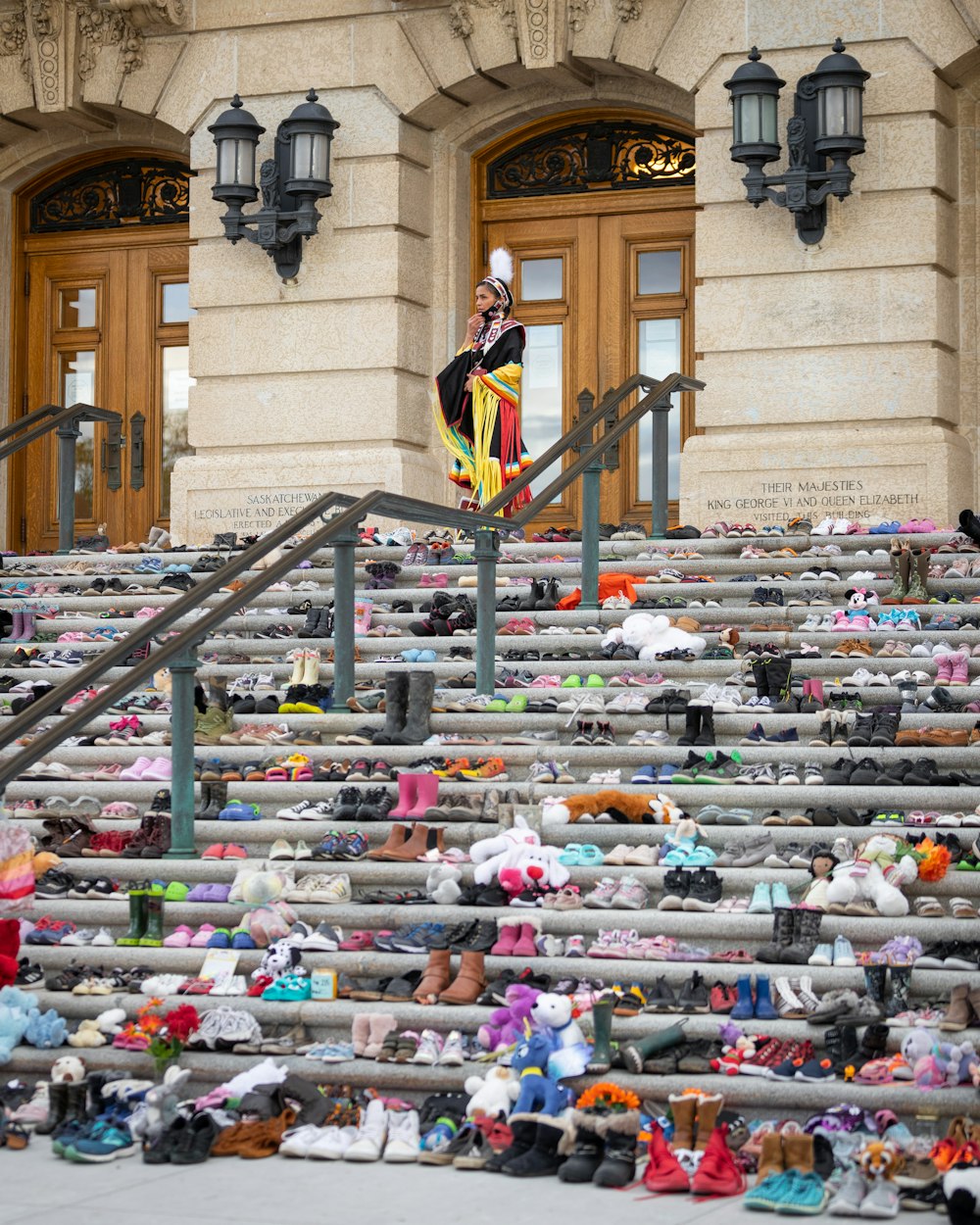 a large pile of shoes sitting on the steps of a building