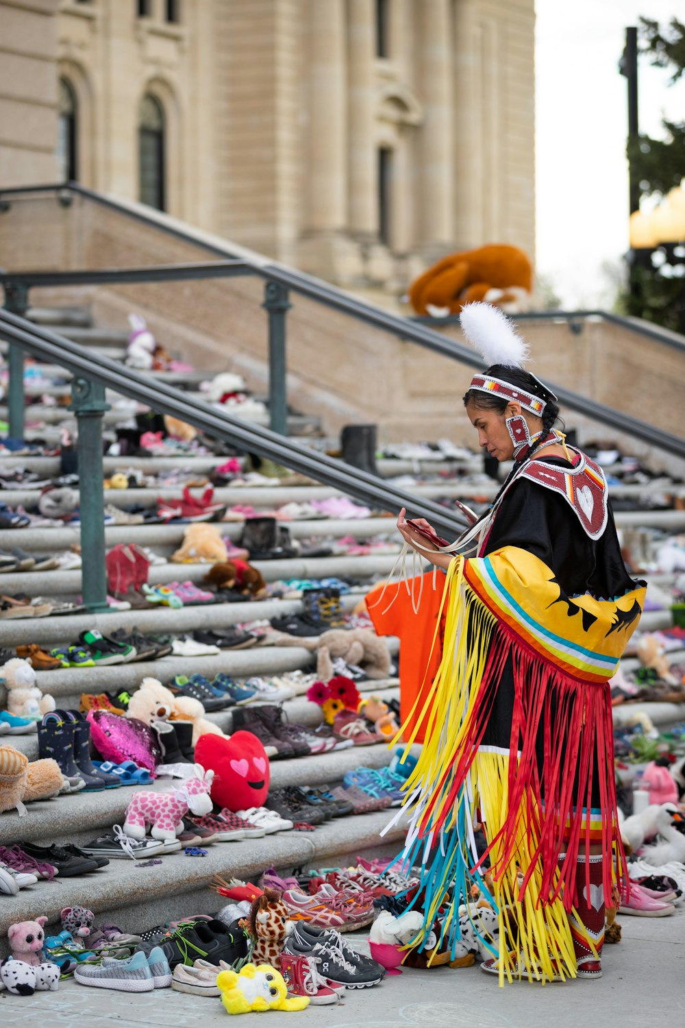 a man dressed in a costume standing next to a bunch of shoes