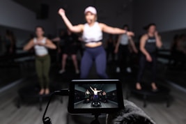 a person taking a picture of a group of dancers