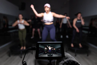 a person taking a picture of a group of dancers