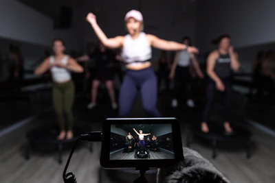 a person taking a picture of a group of dancers