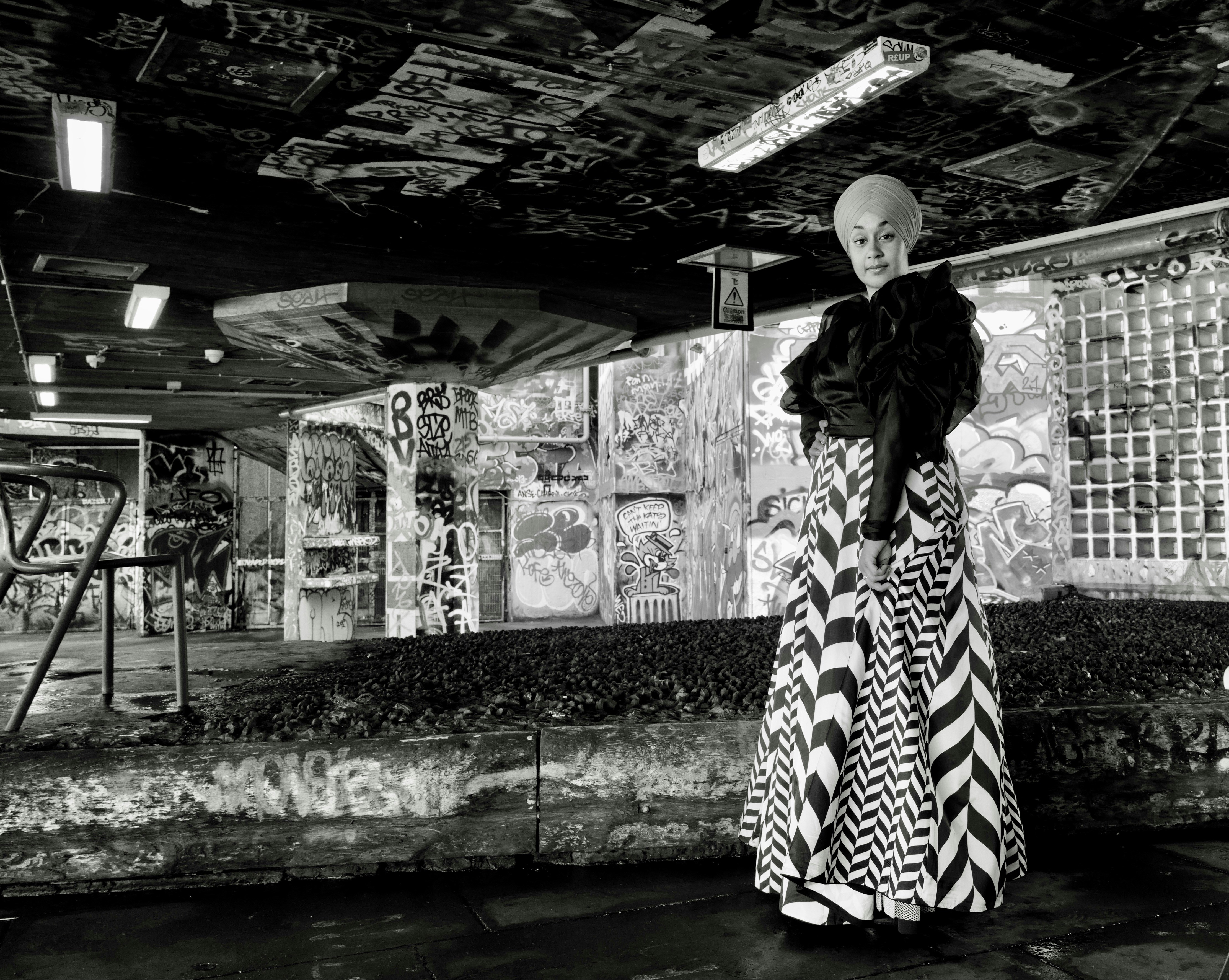 a woman in a long dress standing in a room