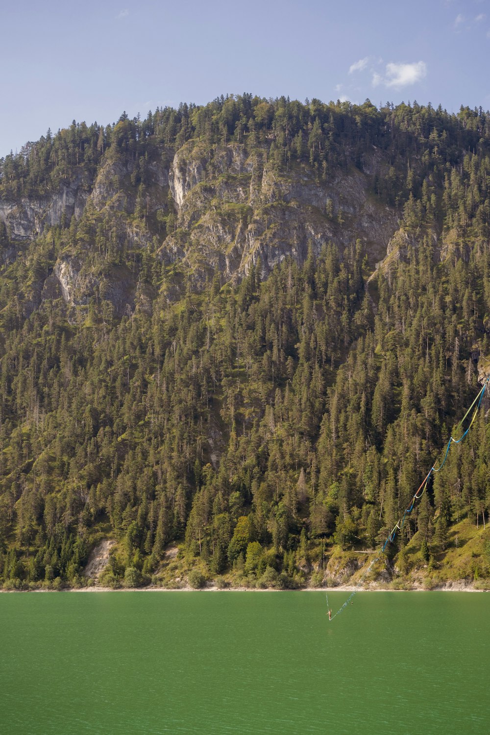 a large body of water with a mountain in the background