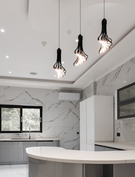 a kitchen with a marble counter top and white cabinets