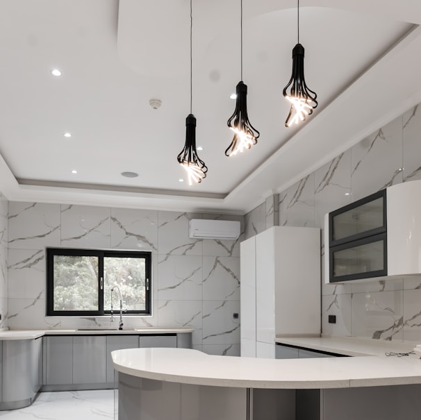 a kitchen with a marble counter top and white cabinets