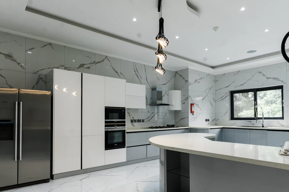 High-end kitchen with marble countertops and stainless steel appliances, an example of premium or luxury-tier residential finishes