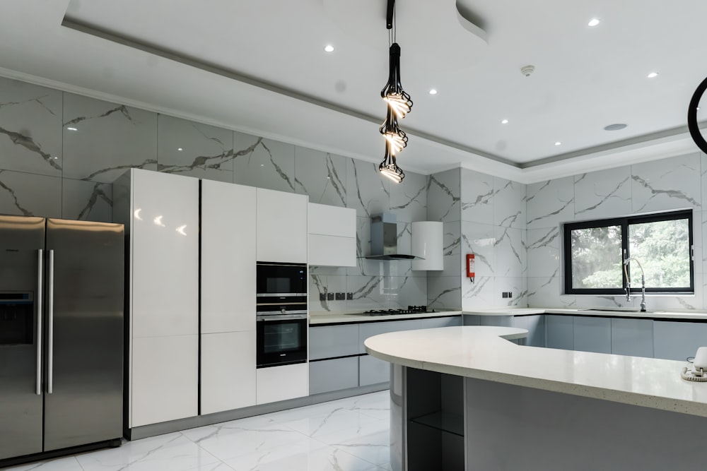 a modern kitchen with marble counter tops and stainless steel appliances