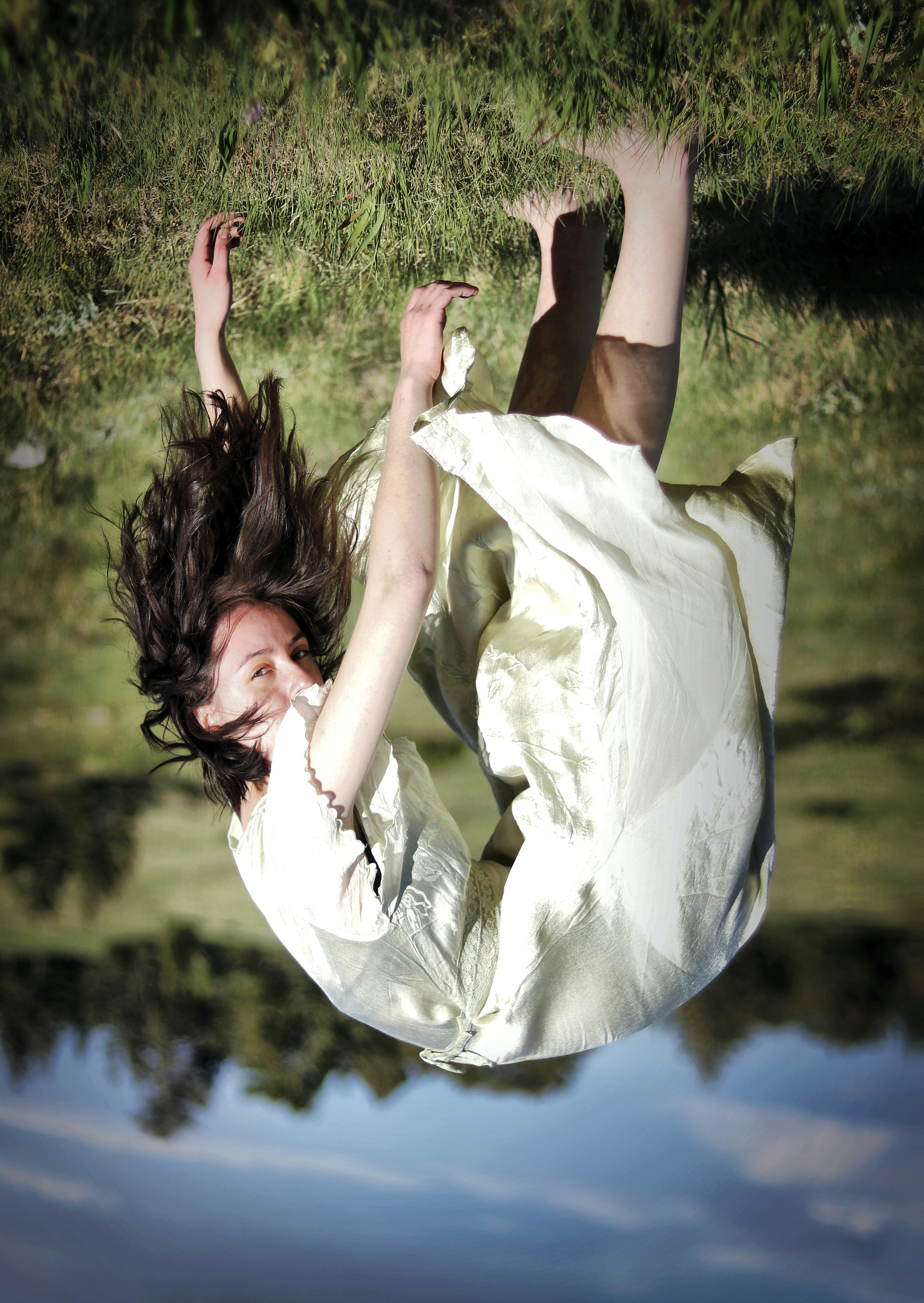 a woman in a white dress flying through the air