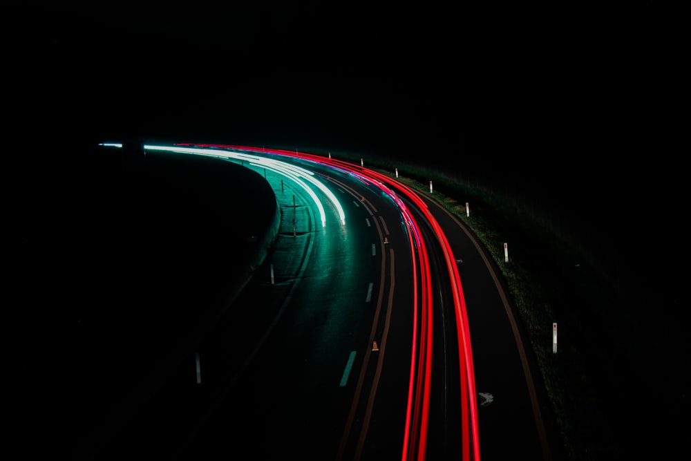 a long exposure photo of a highway at night