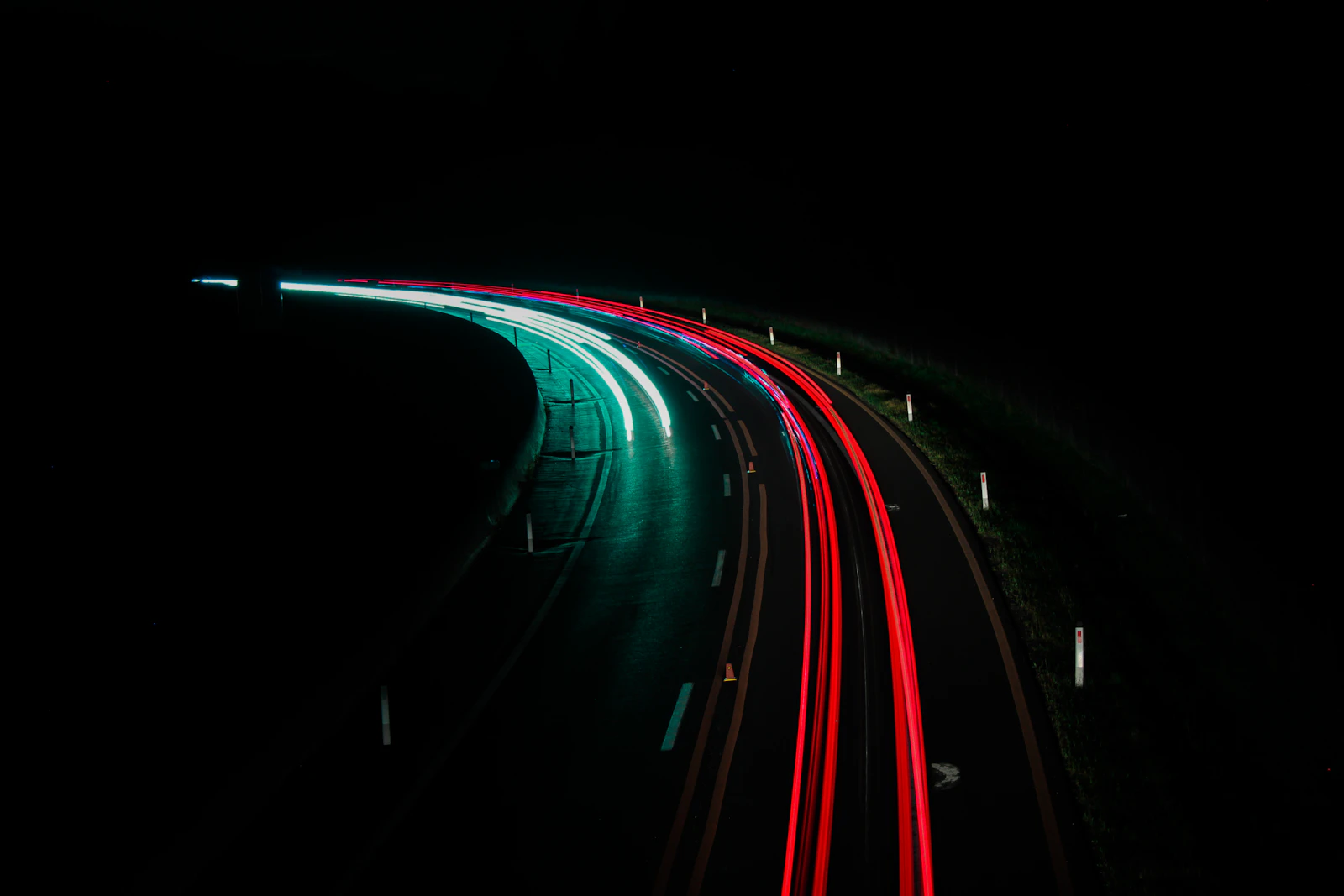 A long exposure photo of a highway at night
