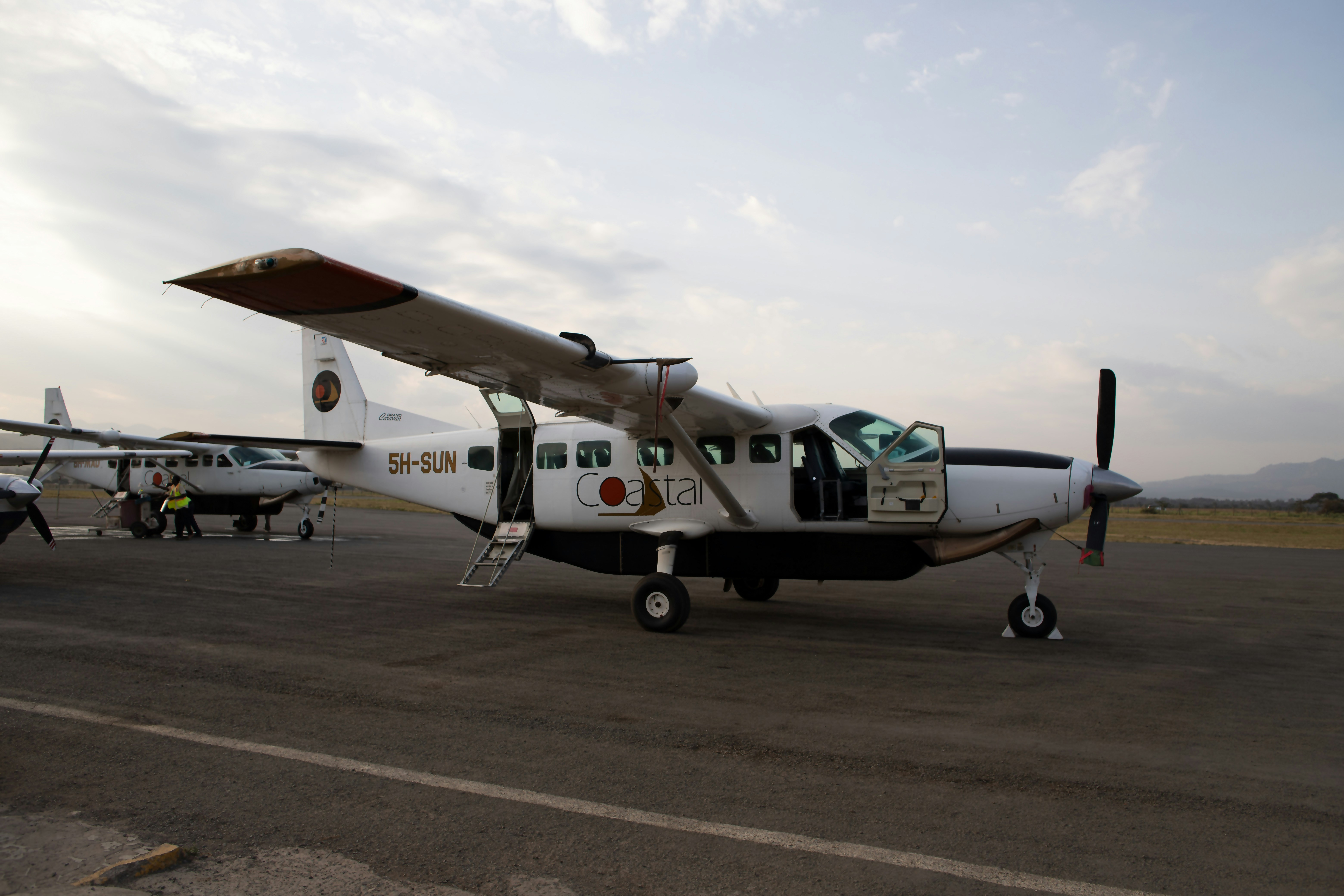 a small airplane sitting on top of an airport tarmac, 
