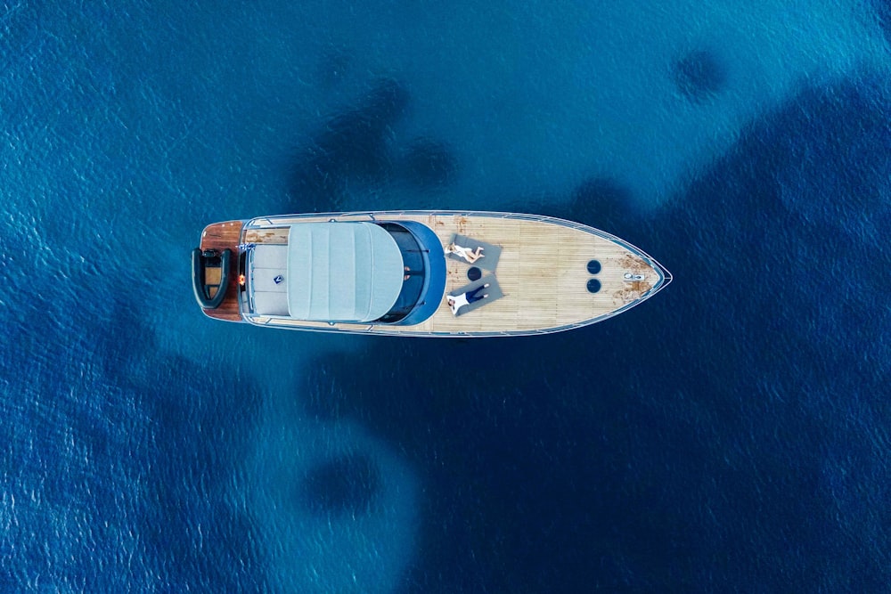 an aerial view of a boat in the ocean