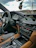 A comfortable car interior showing a friendly driver ready for an outstation trip.