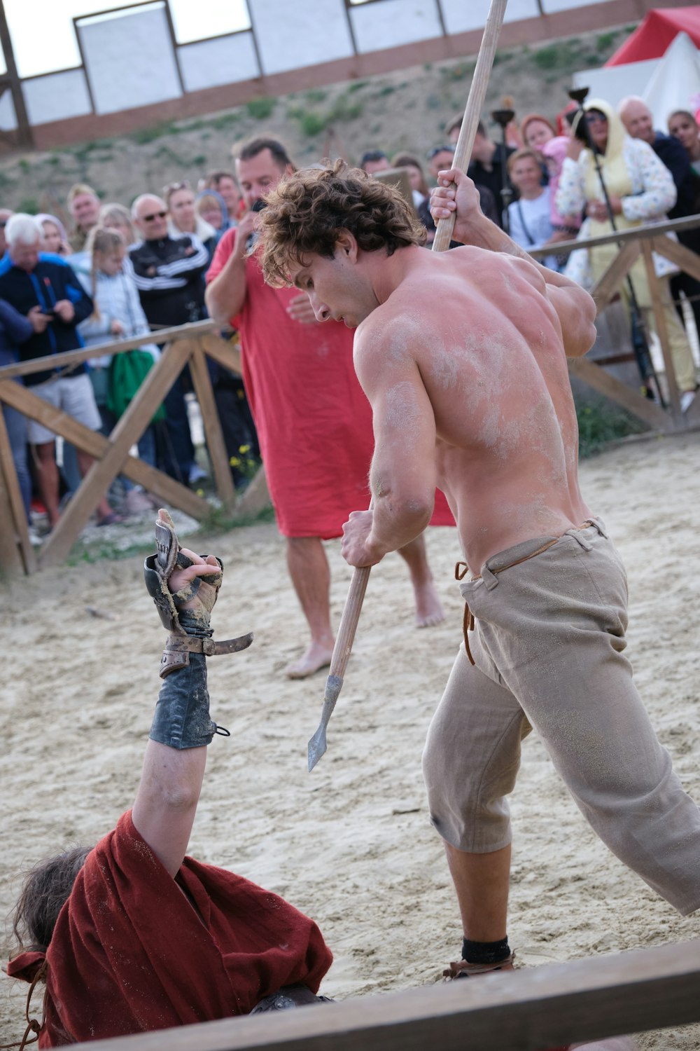 a man holding a sword in front of a crowd of people