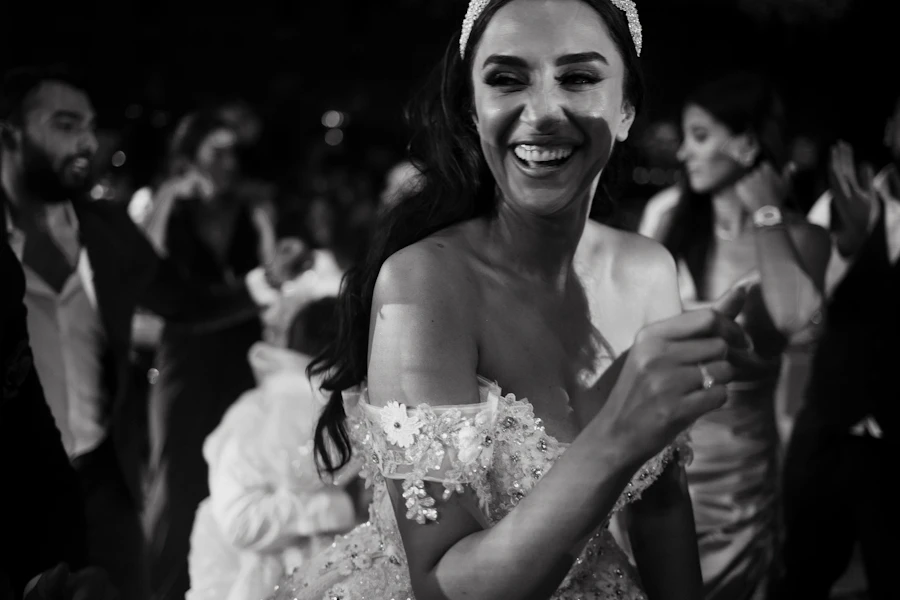 Bride laughing among the guests, black and white