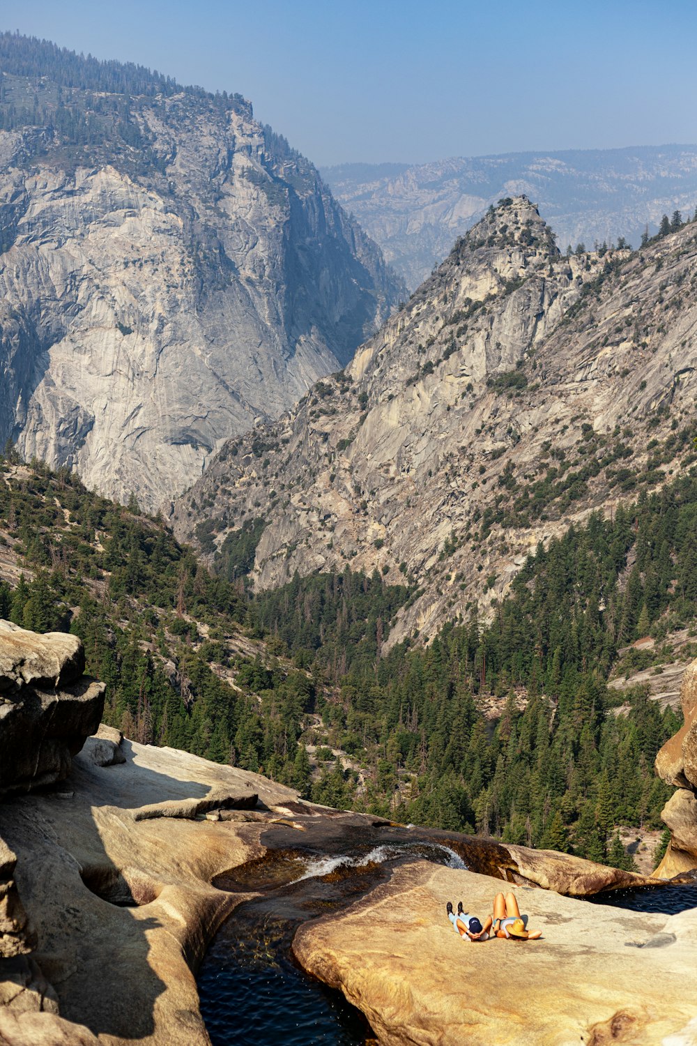 a group of people sitting on top of a mountain