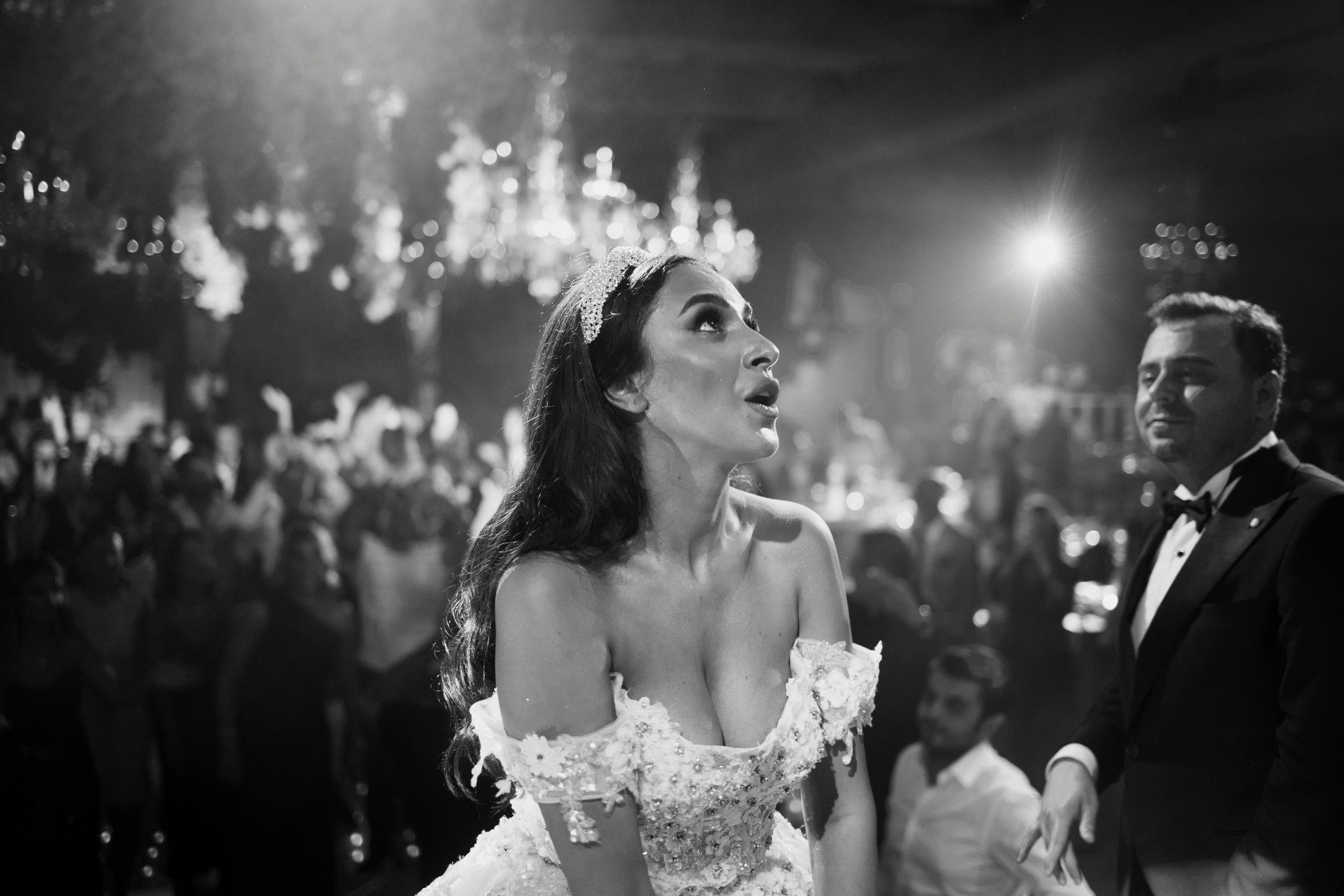 A woman in a white dress standing next to a man in a tuxedo