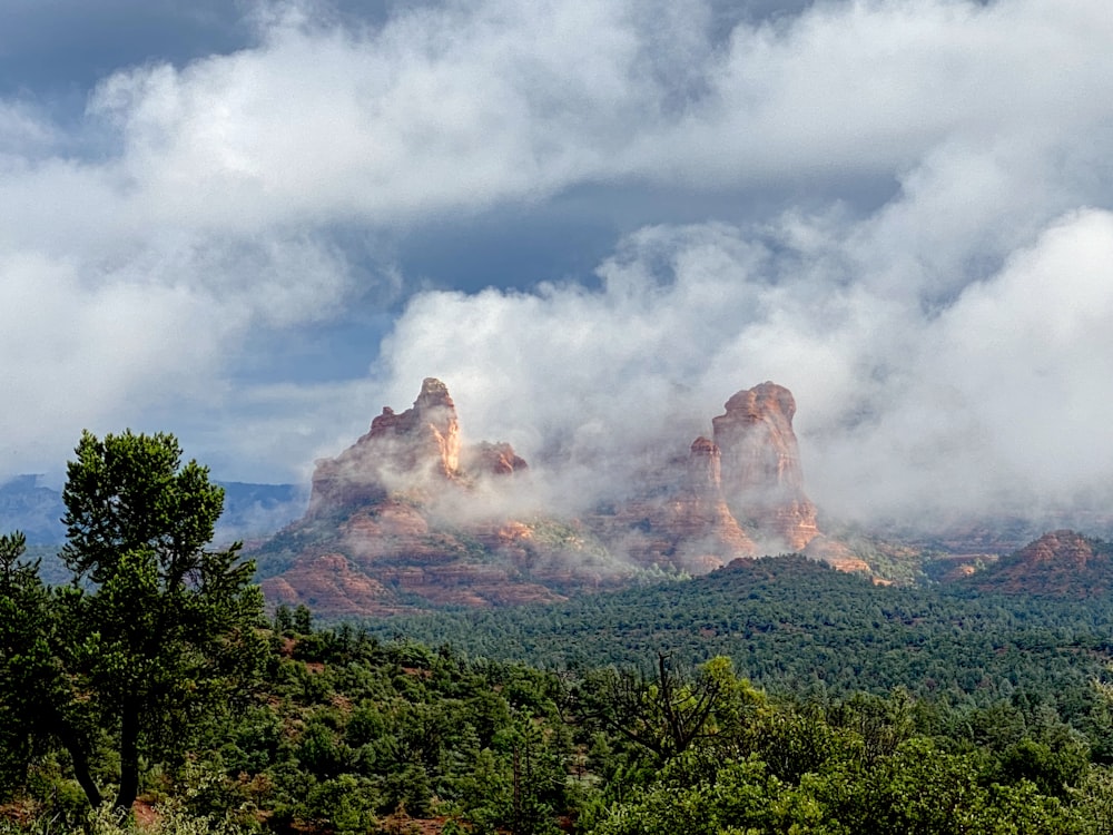 a view of a mountain range with clouds in the sky