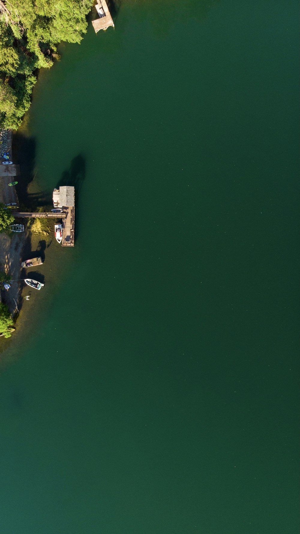 an aerial view of a lake and a house