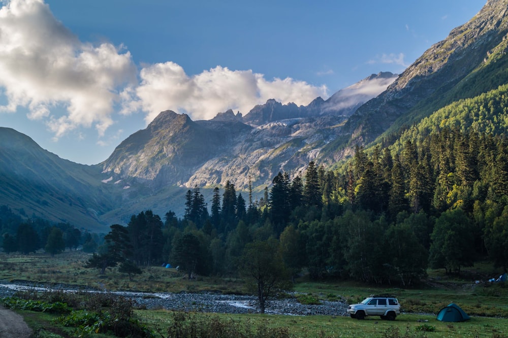 a van is parked in front of a mountain range