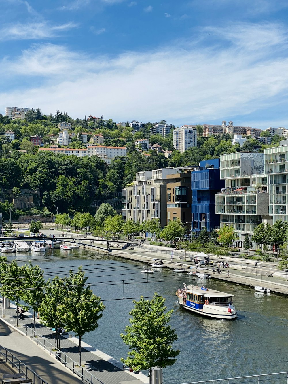 a boat traveling down a river next to tall buildings