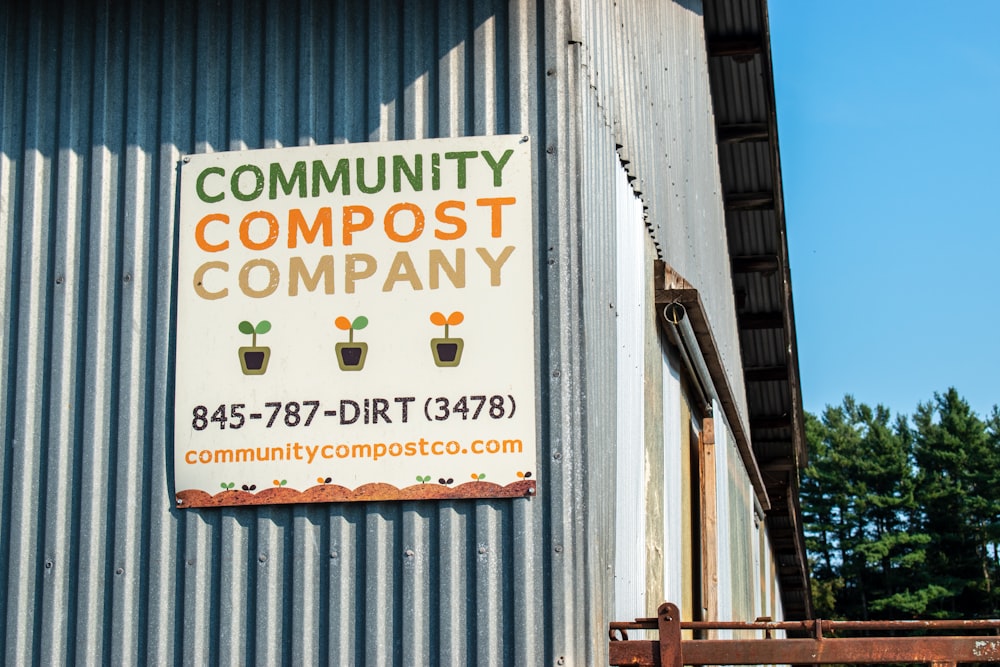 a sign on the side of a building that says community compost company