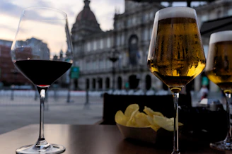 a couple of glasses of wine sitting on top of a table