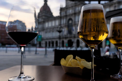 a couple of glasses of wine sitting on top of a table