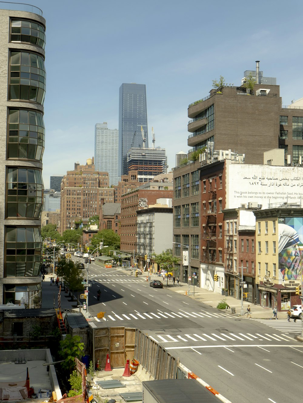 a city street with tall buildings in the background