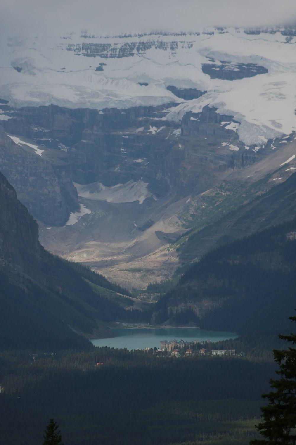 a view of a mountain range with a lake in the foreground