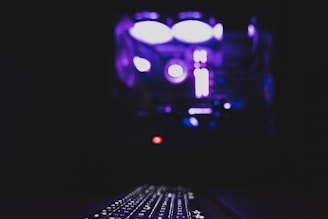 Close-up of a sleek computer setup with glowing keyboard.
