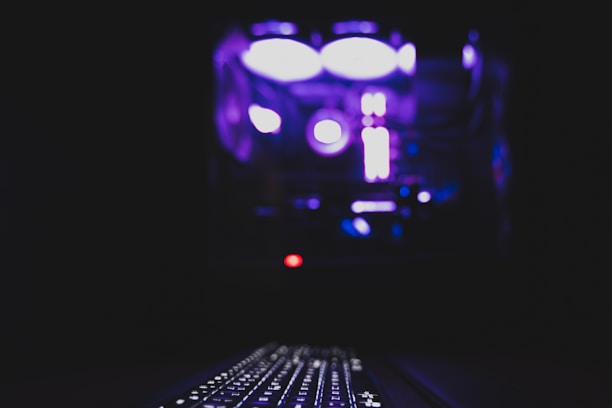 Close-up of a sleek computer setup with glowing keyboard.