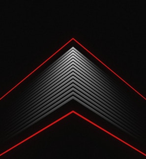 A geometric, abstract design featuring a series of triangular lines converging towards a point at the center top. The design includes repeated black and grey lines with two prominent red lines outlining the top and bottom triangles on a black background.
