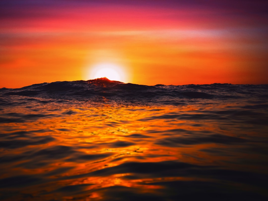 the sun is setting over the ocean as it reflects in the water, Golden Moments