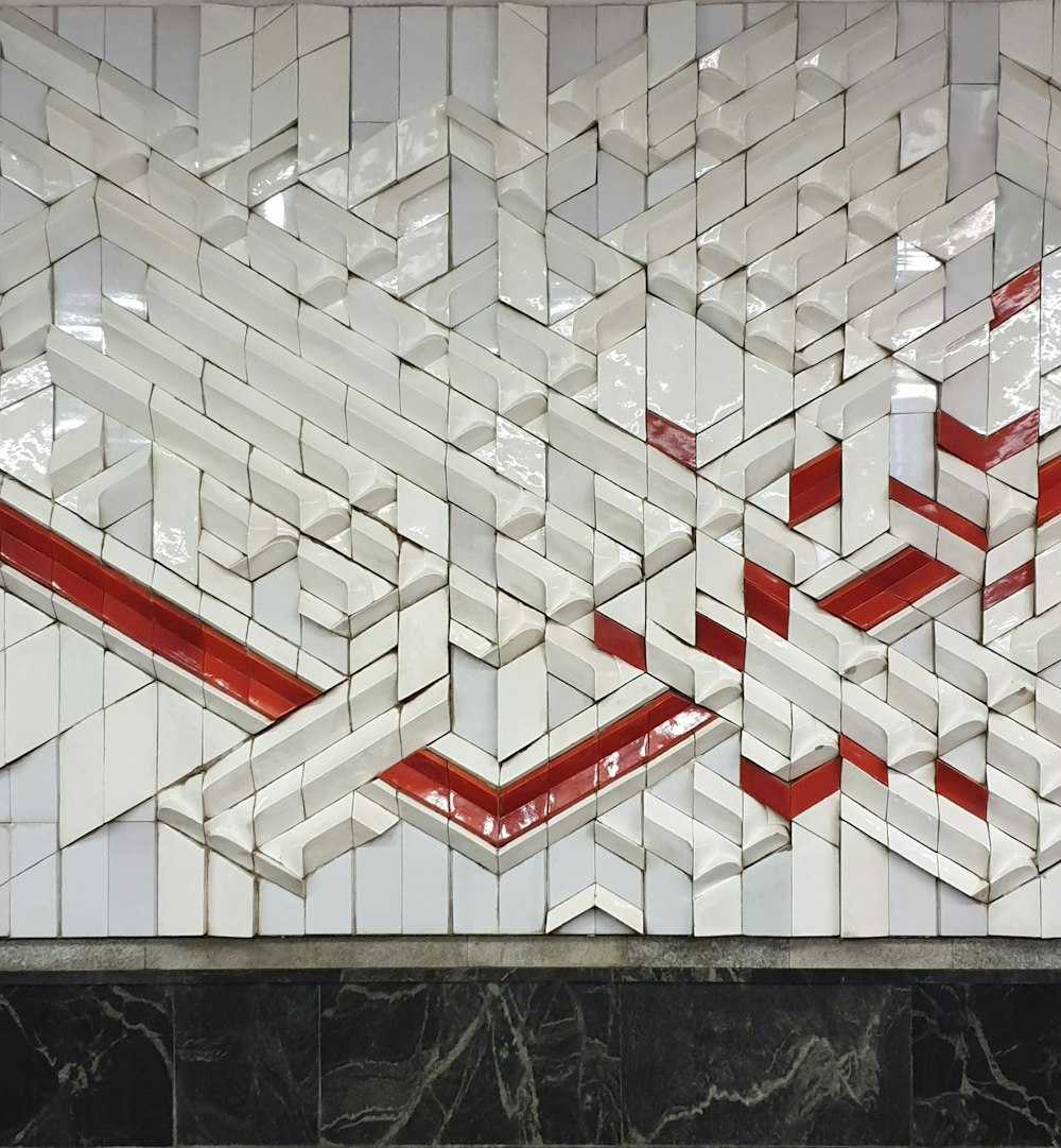 a tiled wall with a red and white design on it