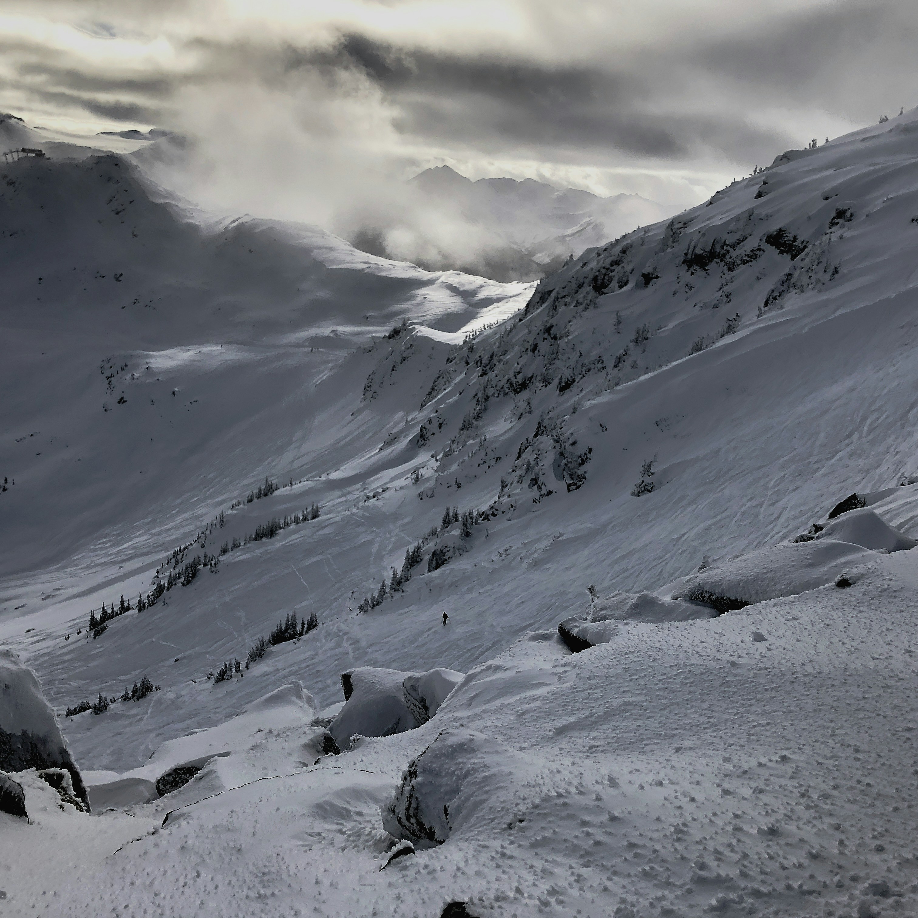 a snow covered mountain with a cloudy sky