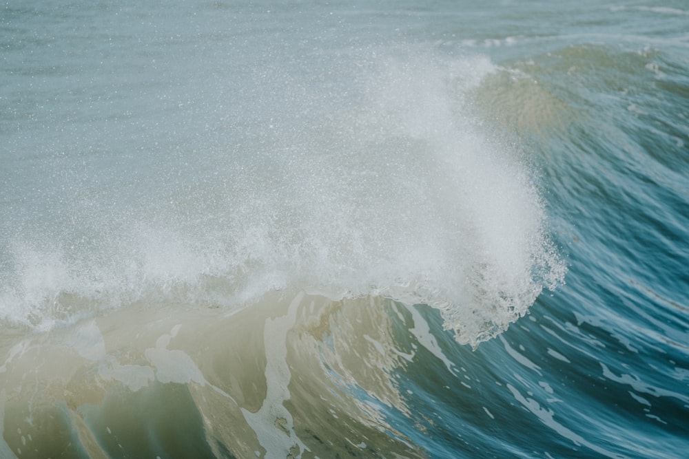 a large wave is breaking over the top of the ocean