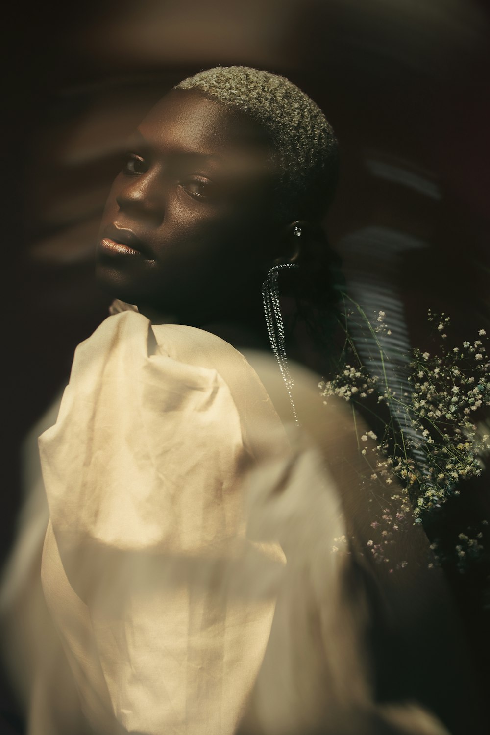 a woman in a white dress with a flower in her hair