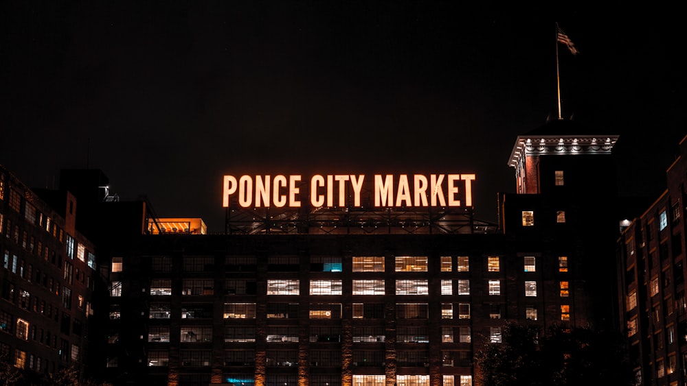 a large neon sign on top of a building