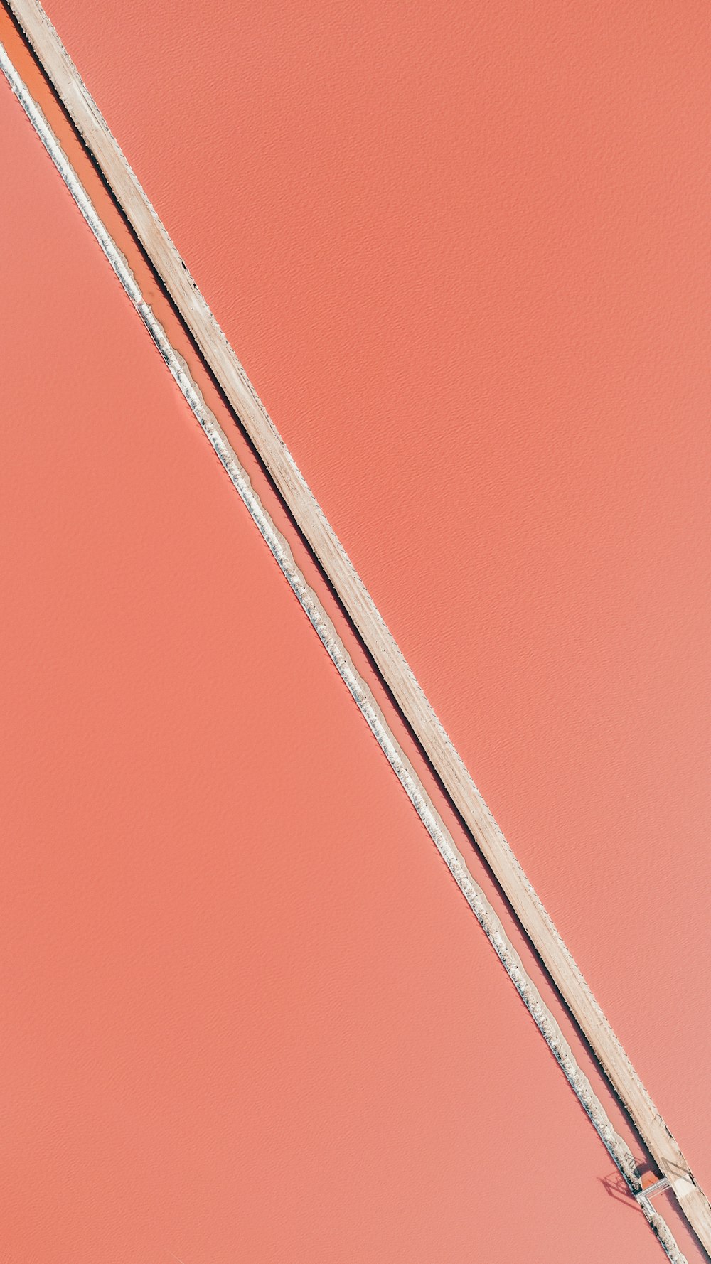 a pair of skis sitting on top of a pink surface